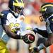 Michigan quarterback Devin Gardner hands the ball off to senior Denard Robinson in the third quarter of the Outback Bowl at Raymond James Stadium in Tampa, Fla. on Tuesday, Jan. 1. Melanie Maxwell I AnnArbor.com